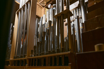 Inside a church organ, register with different pipes from metal, musical instrument