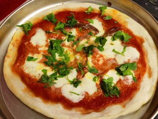Margherita pizza with tomato and mozzarella according to the Italian tradition