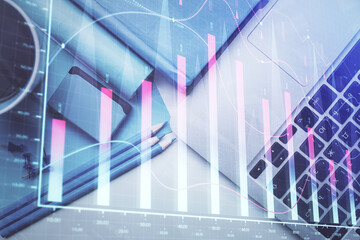 Double exposure of forex graph drawing over desktop background with computer. Concept of financial analysis. Top view.