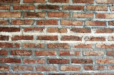 Old red brick wall texture grunge background with vignetted corners, may use to interior design