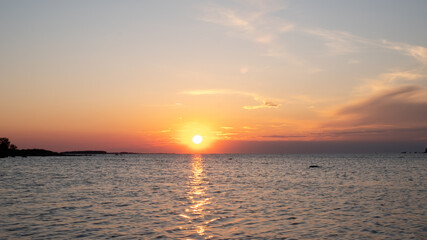 Fototapeta premium Amazing orange golden sunset over the sea. Summer sunset at the Baltic sea, Europe.