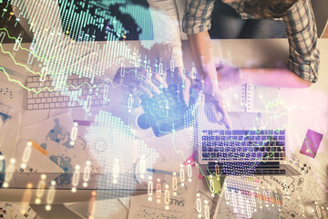 Double exposure of man and woman working together and financial graph hologram drawing. market analysis concept. Computer background. Top View.
