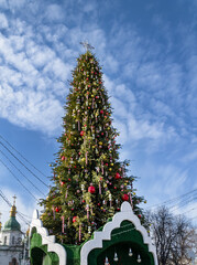 christmas tree with decorations on a background of blue sky