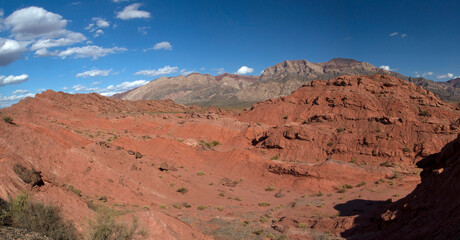 Fototapeta na wymiar The red canyon. Panorama view of the arid desert, valley, sandstone and rocky formations and mountains in Talampaya national park in La Rioja, Argentina. 
