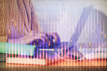 Double exposure of woman hands typing on computer and forex chart hologram drawing. Stock market analysis concept.