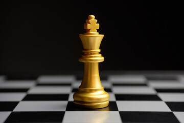 Chess piece golden king on the board