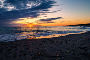 sunset on the beach with dramatic dark cloud