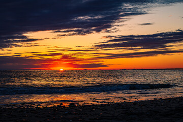 sunset on the beach with dramatic dark cloud