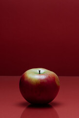 a red apple on a red background