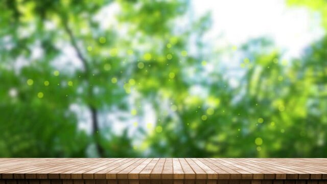 Natural wood table top on a Green leaves and trees with nature blurred in background, bokeh lights moving