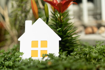 hands holding paper house, family home, homeless shelter and real estate