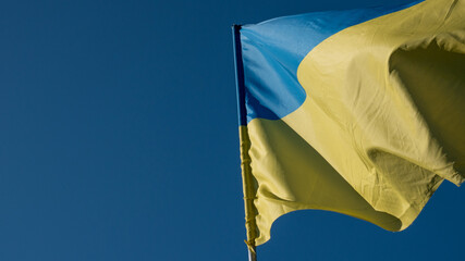 Ukrainian yellow and blue flag waving on a background of blue sky