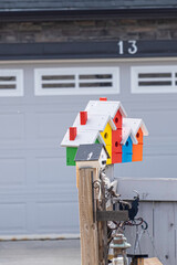 Birdhouse on street on a fence in city