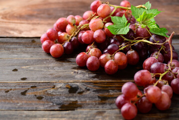 Fresh red grapes fruit on wooden background
