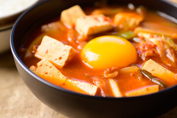 Korean food, Kimchi soup with fofu and egg in a bowl, Close up