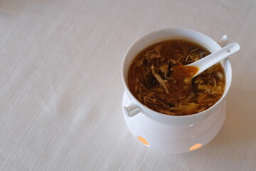 close up Hot and Sour Soup in bowl. Famous traditional Chinese cuisine