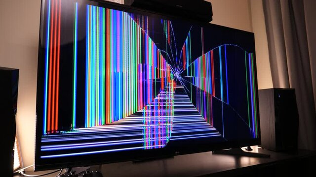 Cracked and broken television in a living room.