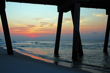 The sun rise, as seen from under the pier