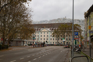 Fototapeta premium Freiburg im Breisgau/Germany - 10 28 2012: Empty european street on the cloudy autumn day after first snow 