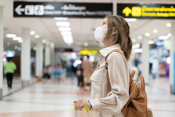 Asian woman wear masks while traveling at the airport terminal. New normal, covid19 disease prevention  concept.