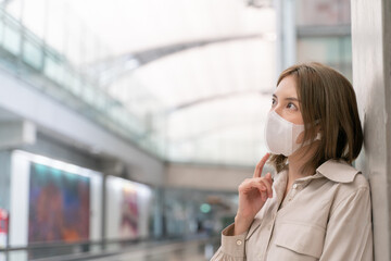 Asian woman wear masks while traveling at the airport terminal. New normal, covid19 disease...