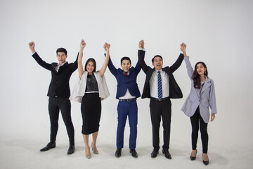 Fototapeta premium Business People Team Success Celebration Concept, Celebrating success. Group of young business people raising their arms. young asian Business people raising their hands up to celebrating success