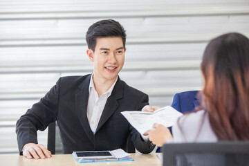 Business manager give papers presenting document report business plan to team people at corporate meeting