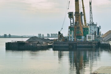 Fototapeta premium Loading and unloading operations in the cargo port, 29 07 2020, Rybinsk, Russia.