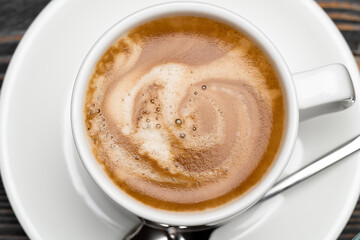 close up of foamy hot fresh espresso coffee cup
