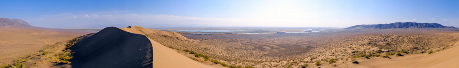 Sand dunes with clouds backgorund. Natural landscape. Altyn-Emel singing dunes or barkhan. Altyn-emel national park in Kazakhstan. Tourism travel in Kazakhstan concept.