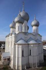 Beautiful white Christian Church on the background of blue sky and sun, historical landscape, architectural ensemble