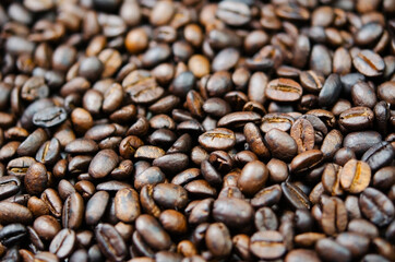 Dark roasted coffee beans close-up. Coffee background