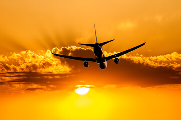 Passenger airplane flying above clouds during sunset. Travel concept, air travel