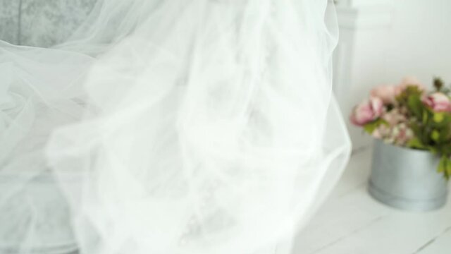 the bride's wedding veil lies on the sofa