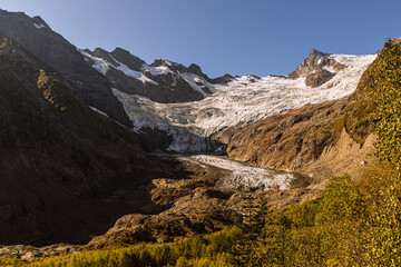 Alibek glacier. Autumn in Caucasus mountain. Eco tourism and hiking in mountain, travel destination.