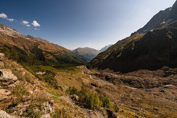 Canyon of mountain river with blue water. Autumn in Caucasus mountain. Hiking and eco tourism in mountain.