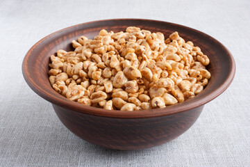 delicious airy wheat in honey glaze in a clay bowl