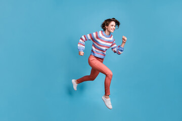 Full length body size side profile photo of jumping high running fast girl smiling isolated on...