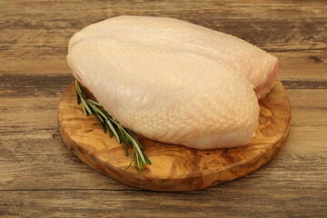 Raw whole chicken breast with skin