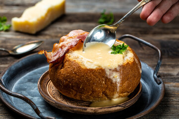 cheese cream soup with potato and bacon on a rustic background. banner, catering menu recipe