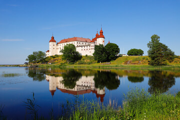 Fototapeta na wymiar Scenic view of the Swedish medieval Lacko castle is a beautiful landmark reflected in the lake.