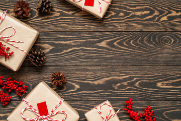Christmas presents wrapped in craft paper and decorated with holly berries, tags and twine string...