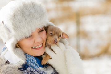 Woman playing with dog during winter