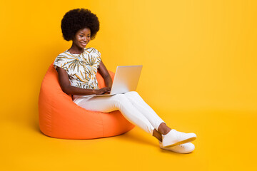 Full size photo of young beautiful afro smiling positive girl woman sit armchair work laptop...