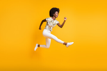 Full size profile side photo of young african attractive crazy smiling girl woman female jump fly isolated on yellow color background