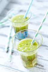 Green smoothie topped with chia seeds on bright wooden background. Close up.	