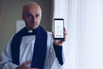 Man priest holding a cell phone with information about online church meetings