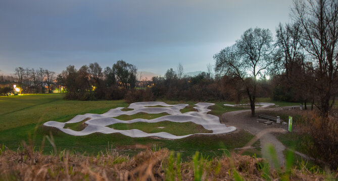Overview of an empty pump track in evening hours. Popular pumptrack resting peacfully in the evening in fall.