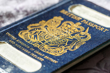 An old blue British Passport with a gold insignia in selective focus. The British passport is due to return to use when Britain leaves the European Union in December 2020.