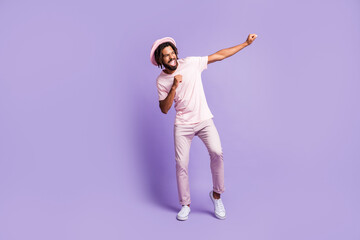 Fototapeta na wymiar Full size photo of young handsome afro crazy excited happy man guy dancing look copyspace isolated on purple color background